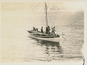 Image of Eskimos [Inuit] in small sailing boat; two kayaks aboard
